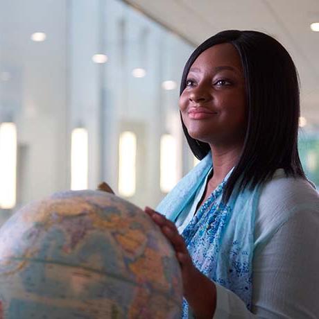 Female student holding globe